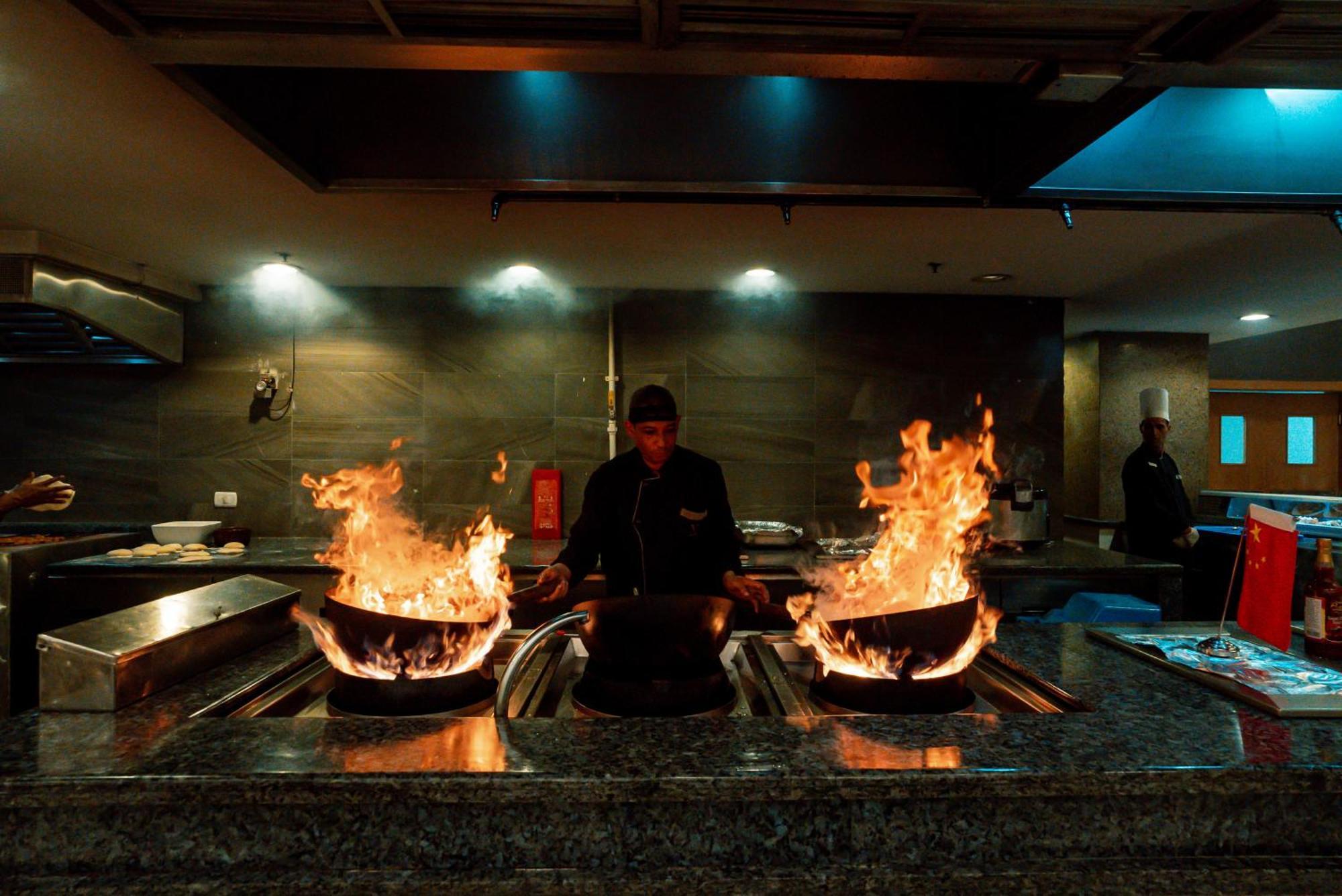 The V Luxury Resort Sahl Hasheesh Hurghada Extérieur photo A chef cooking with a wok